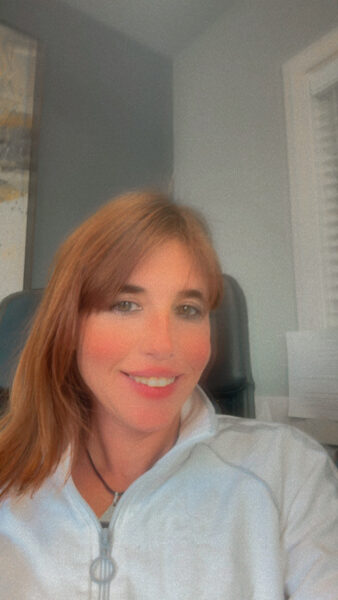 Owner of Bella’s Mountain Vacation Cleaning wearing a striped shirt, photographed in natural sunlight, representing friendly and professional vacation rental cleaning services in Golden, Colorado.